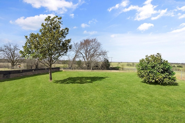 view of yard featuring fence and a rural view