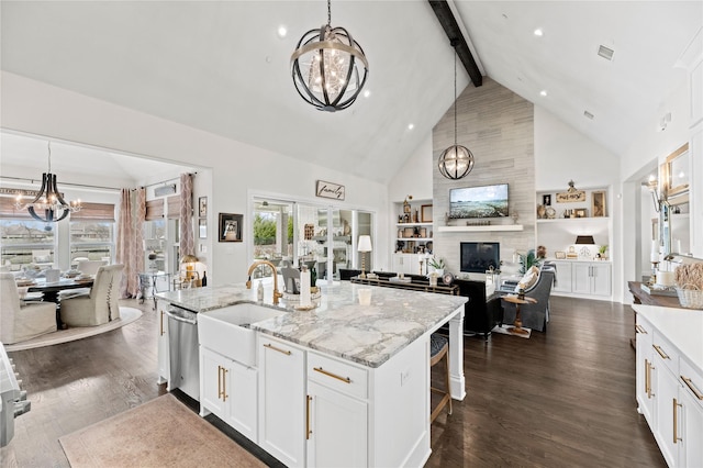 kitchen with a sink, dishwasher, beam ceiling, a notable chandelier, and dark wood-style flooring