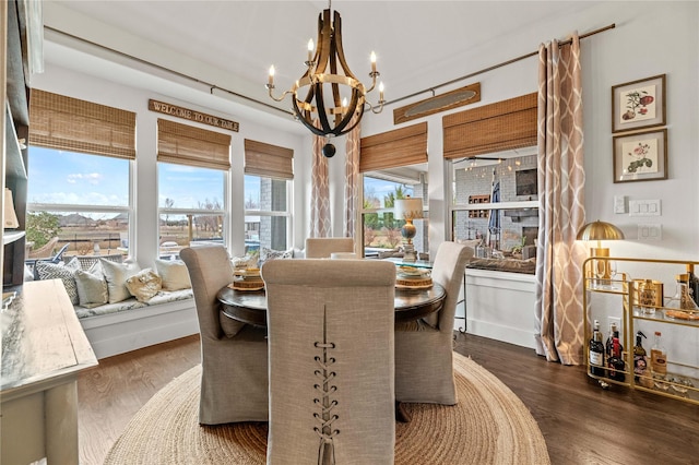 dining space featuring a chandelier and wood finished floors