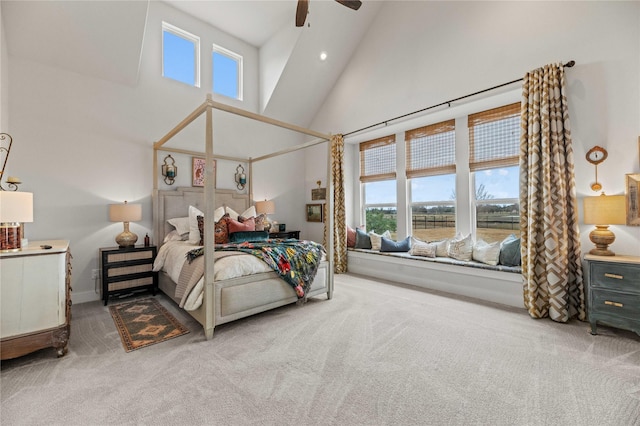 carpeted bedroom featuring high vaulted ceiling and ceiling fan