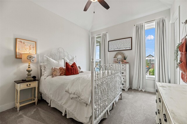 carpeted bedroom featuring ceiling fan, baseboards, and lofted ceiling