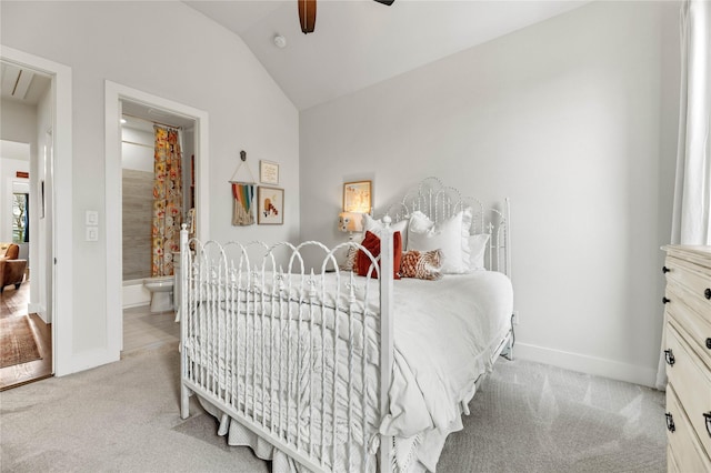 carpeted bedroom with baseboards, attic access, ceiling fan, and vaulted ceiling