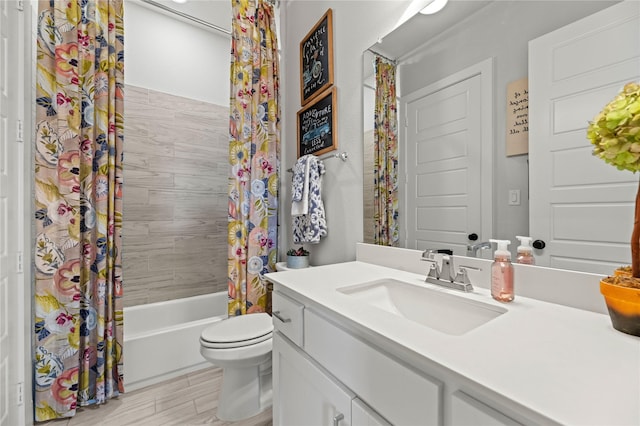 bathroom featuring shower / tub combo, toilet, wood finished floors, and vanity