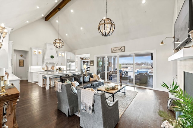 living room featuring dark wood finished floors, beam ceiling, high vaulted ceiling, and a chandelier