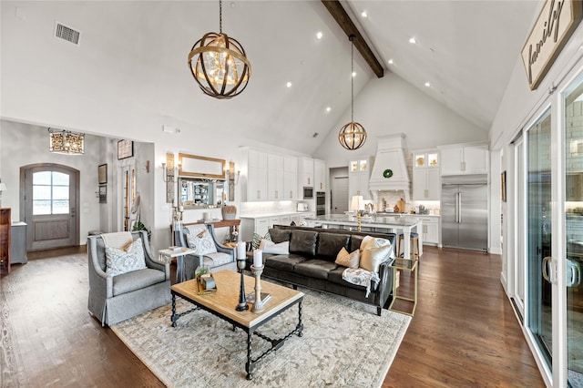 living room featuring visible vents, beam ceiling, an inviting chandelier, and dark wood-style floors