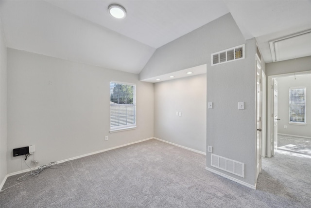 1153 Regal Dr, Garland, TX 75040 - carpeted spare room featuring attic access, lofted ceiling, and baseboards