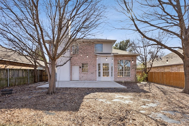 1153 Regal Dr, Garland, TX 75040 - back of property featuring brick siding, a patio area, and a fenced backyard