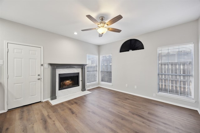 1153 Regal Dr, Garland, TX 75040 - unfurnished living room with a ceiling fan, a high end fireplace, wood finished floors, baseboards, and recessed lighting