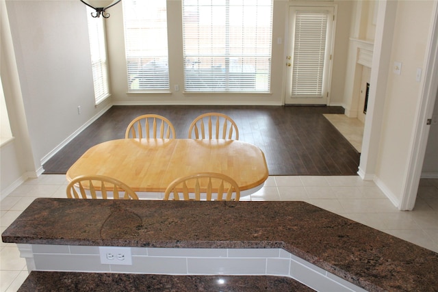 8509 Mustang Dr, Irving, TX 75063 - unfurnished dining area with tile patterned flooring, a fireplace, and baseboards