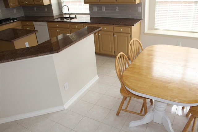 8509 Mustang Dr, Irving, TX 75063 - kitchen with light tile patterned floors, decorative backsplash, black gas stovetop, white dishwasher, and a sink