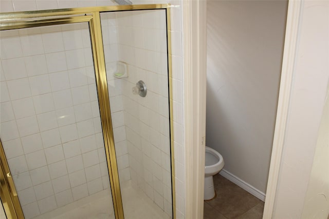 8509 Mustang Dr, Irving, TX 75063 - bathroom featuring toilet, a shower stall, and tile patterned flooring