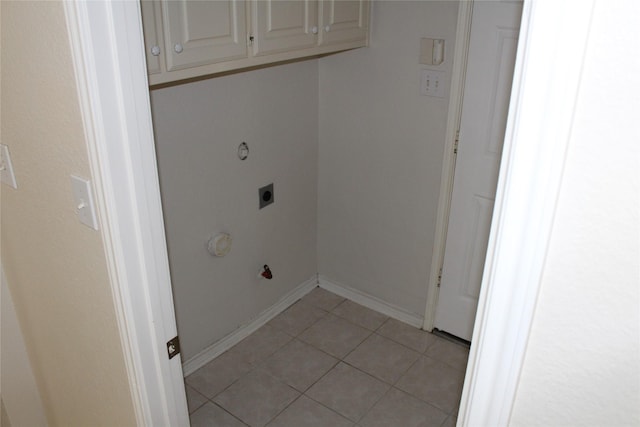 8509 Mustang Dr, Irving, TX 75063 - washroom featuring baseboards, light tile patterned floors, hookup for a gas dryer, cabinet space, and hookup for an electric dryer
