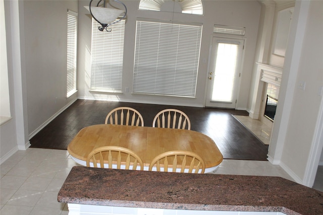 8509 Mustang Dr, Irving, TX 75063 - dining area featuring light tile patterned floors, a fireplace, and baseboards