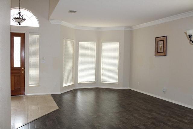 8509 Mustang Dr, Irving, TX 75063 - foyer featuring baseboards, visible vents, dark wood-style flooring, and ornamental molding