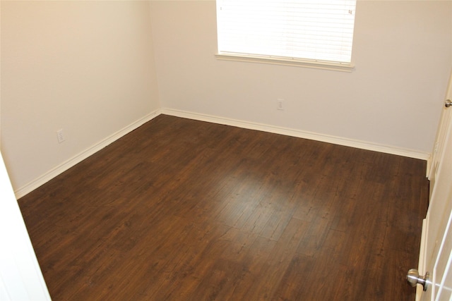 8509 Mustang Dr, Irving, TX 75063 - unfurnished room featuring baseboards and dark wood-style floors