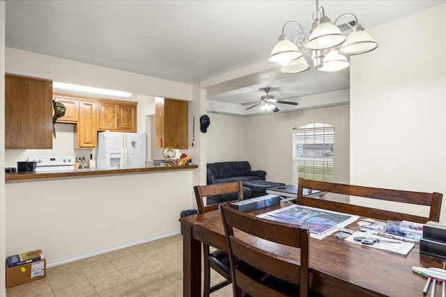 dining room featuring baseboards and ceiling fan with notable chandelier