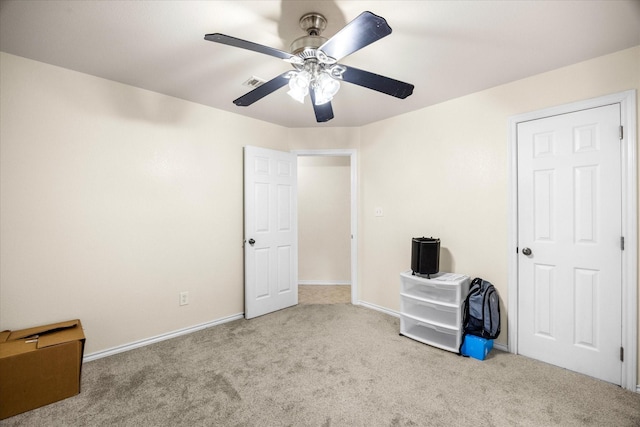 unfurnished bedroom with carpet floors, visible vents, baseboards, and a ceiling fan