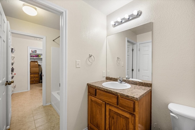 bathroom featuring toilet, tile patterned flooring, and vanity