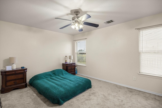 bedroom with a ceiling fan, carpet, visible vents, and baseboards