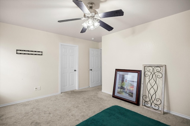 unfurnished bedroom featuring a ceiling fan, baseboards, and carpet flooring