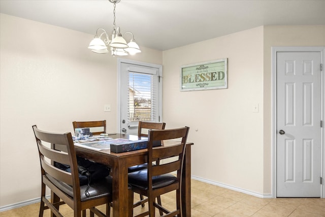 dining room with a chandelier, light tile patterned flooring, and baseboards