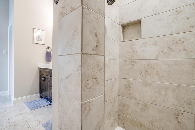 room details featuring a tile shower and vanity