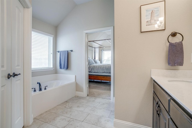 bathroom with baseboards, ensuite bath, a garden tub, vaulted ceiling, and vanity