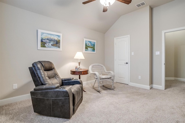 sitting room with lofted ceiling, carpet flooring, visible vents, and baseboards