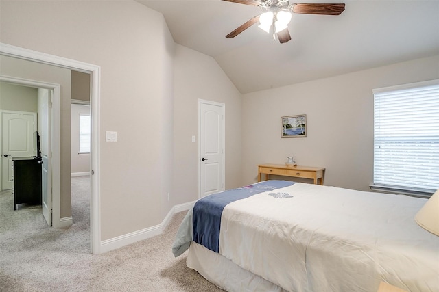 bedroom featuring a ceiling fan, baseboards, vaulted ceiling, and carpet flooring