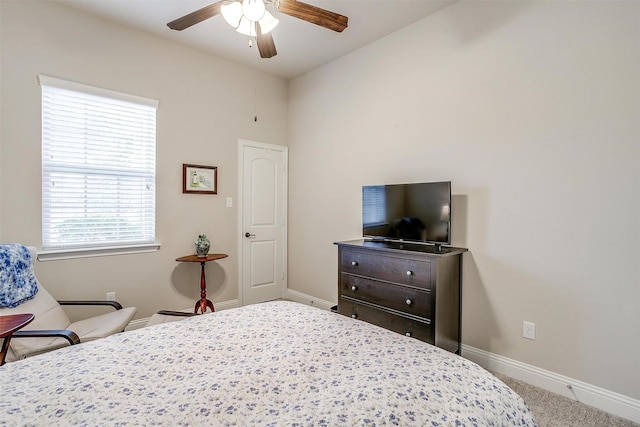 carpeted bedroom with a ceiling fan and baseboards