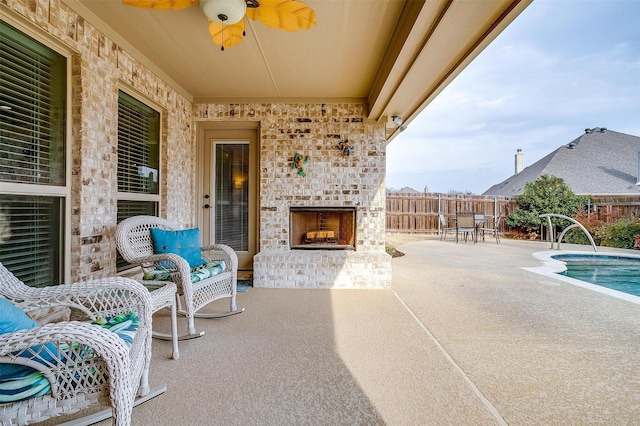 view of patio with a fenced in pool, outdoor dining space, ceiling fan, an outdoor brick fireplace, and a fenced backyard