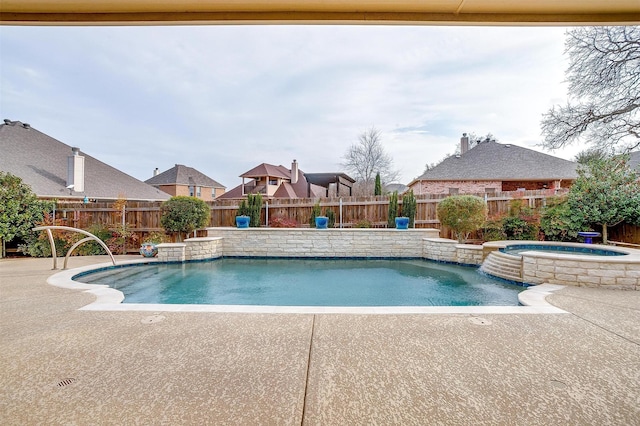 view of swimming pool with a patio area, a fenced backyard, and a pool with connected hot tub