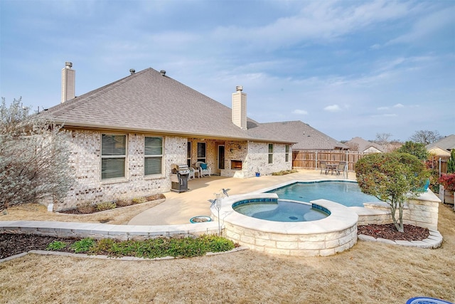 view of swimming pool with a fenced backyard, a pool with connected hot tub, and a patio