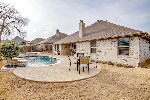 view of pool with a lawn, a patio area, a fenced backyard, and a pool with connected hot tub