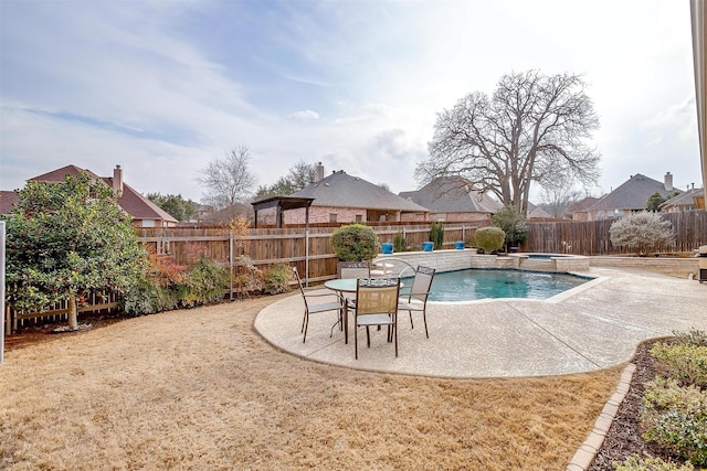 view of swimming pool featuring a patio area, a fenced backyard, and a pool with connected hot tub