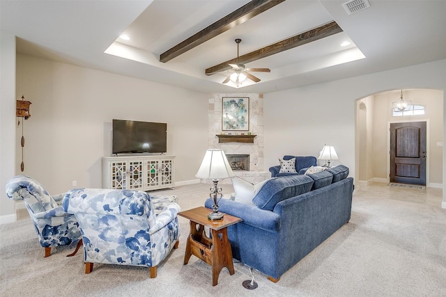 living area with arched walkways, carpet, and visible vents