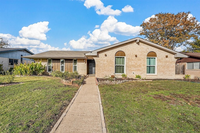 single story home with brick siding and a front yard