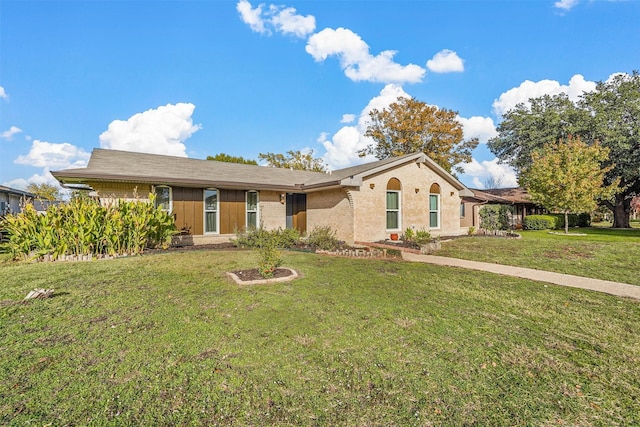 ranch-style home with brick siding and a front yard