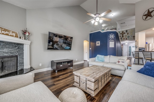 living room with baseboards, visible vents, high vaulted ceiling, arched walkways, and dark wood-type flooring