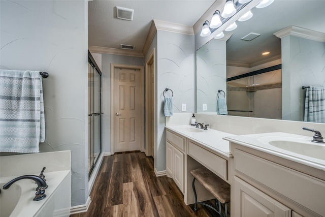 full bathroom featuring double vanity, visible vents, a shower stall, and ornamental molding