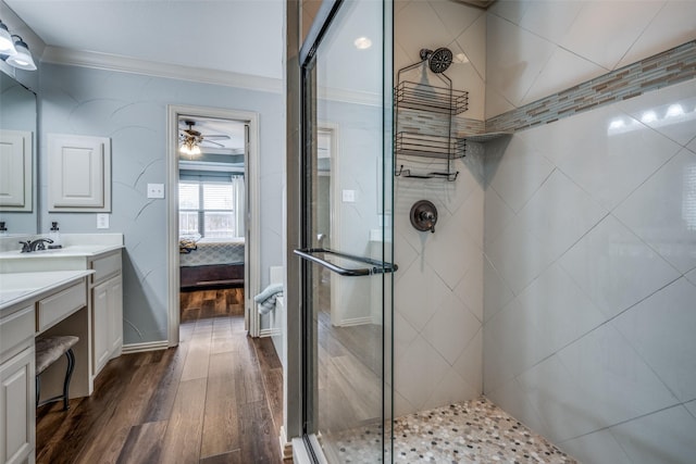 bathroom with a stall shower, wood finished floors, ensuite bath, and vanity