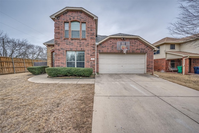 traditional-style home with concrete driveway, a garage, fence, and brick siding