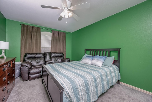 carpeted bedroom featuring baseboards and a ceiling fan