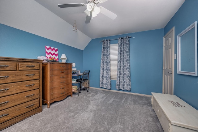 carpeted office with lofted ceiling, baseboards, and ceiling fan