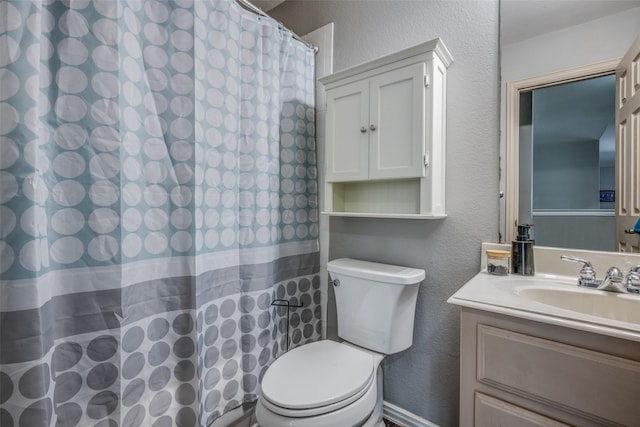 full bathroom with a shower with shower curtain, toilet, vanity, and a textured wall