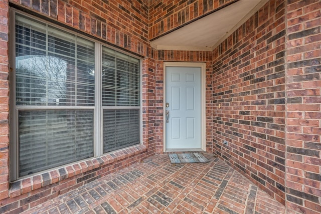 property entrance with brick siding