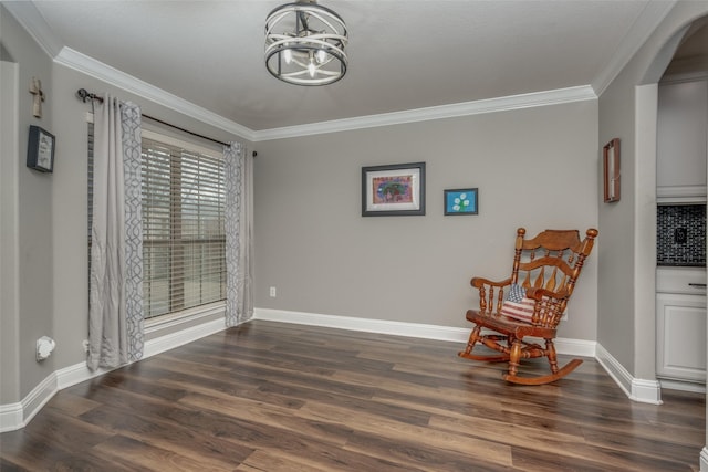 sitting room featuring crown molding, a notable chandelier, baseboards, and dark wood-style flooring