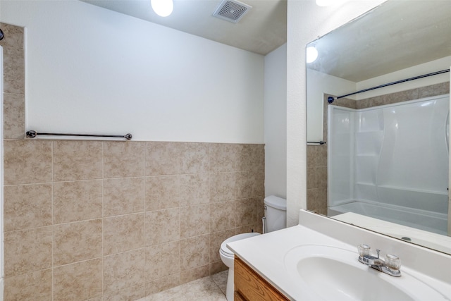 full bath with visible vents, tile walls, toilet, and walk in shower
