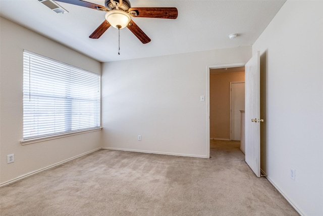 unfurnished room with light carpet, ceiling fan, and visible vents
