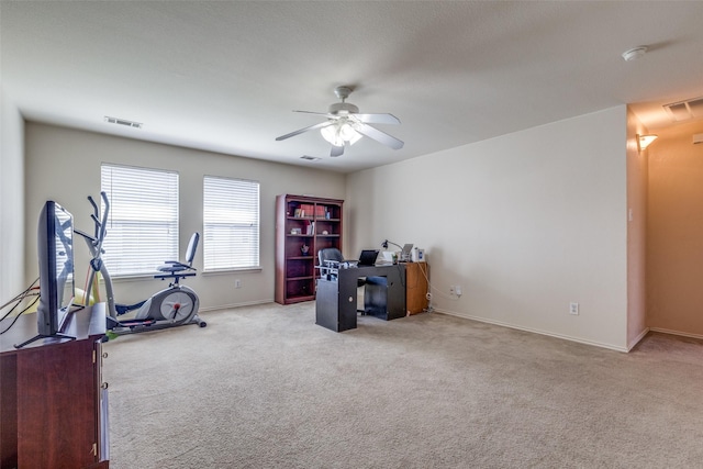 workout area featuring carpet flooring, visible vents, and a ceiling fan